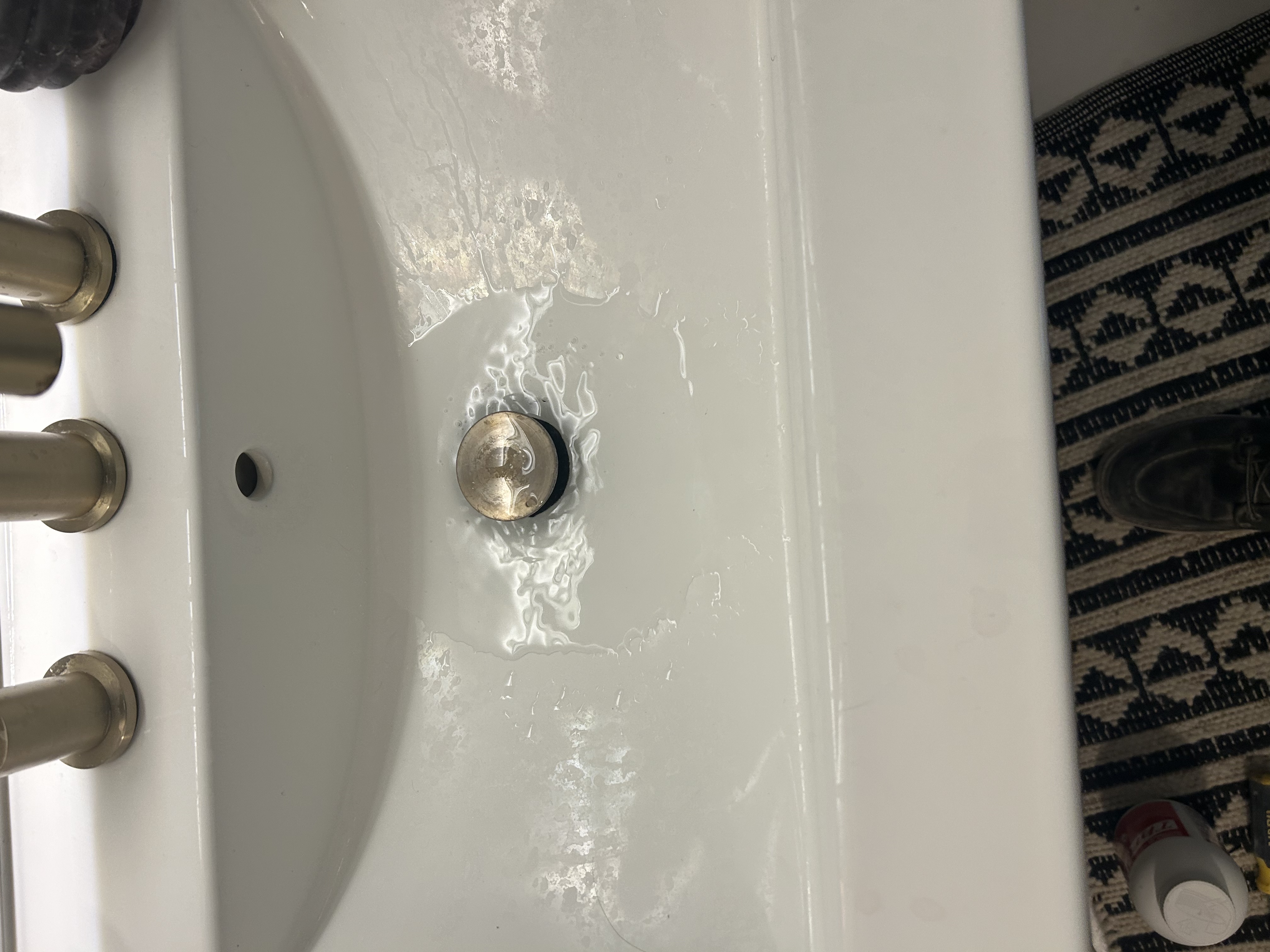 Debris and hair removed from sink P-trap in Scottsdale AZ rental bath — blockage causing slow drain — Desert Rain Plumbing