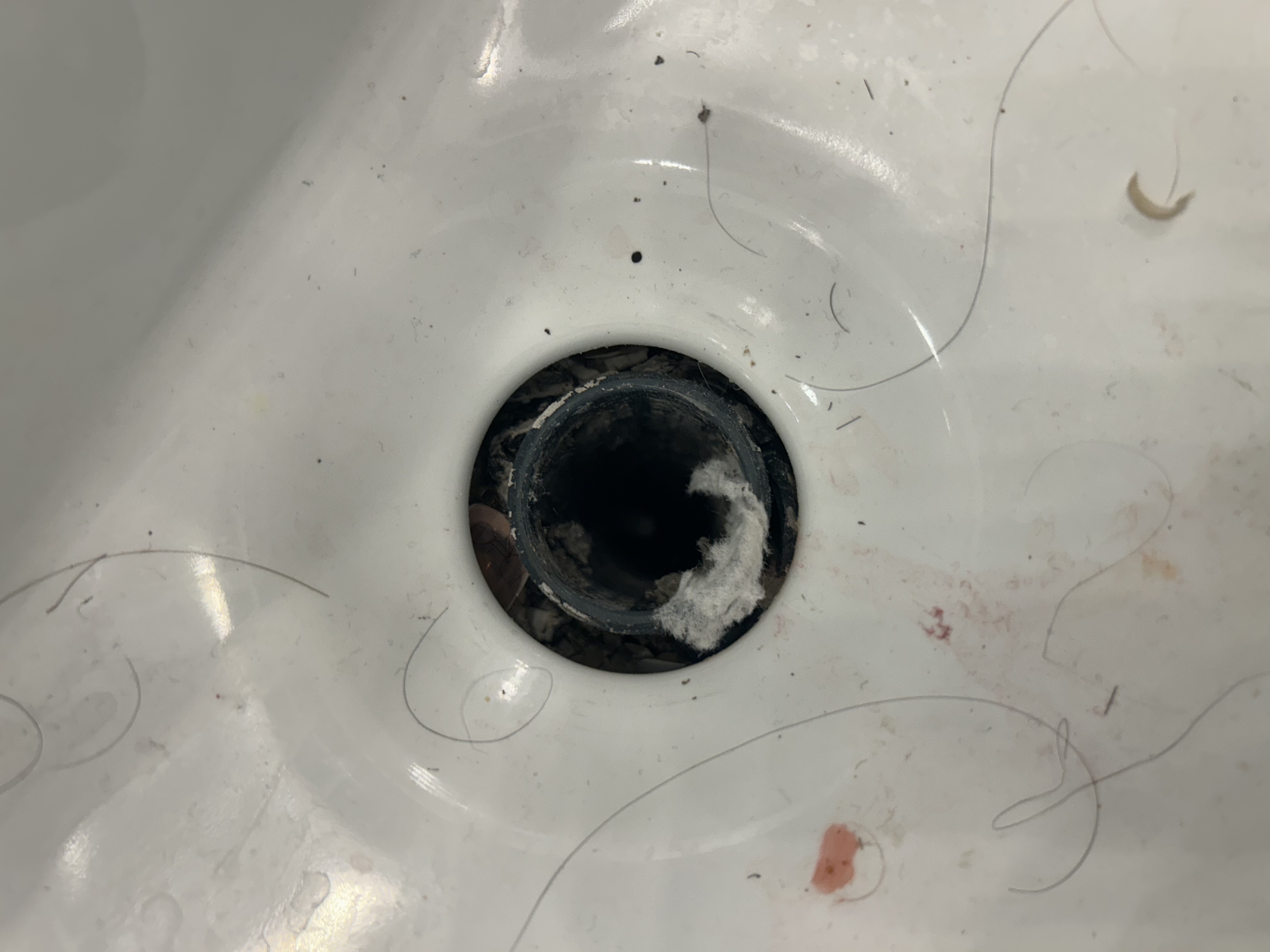 Master bath sink drain open after broken pop-up assembly removed — mineral scale visible inside pipe — Peoria AZ plumber