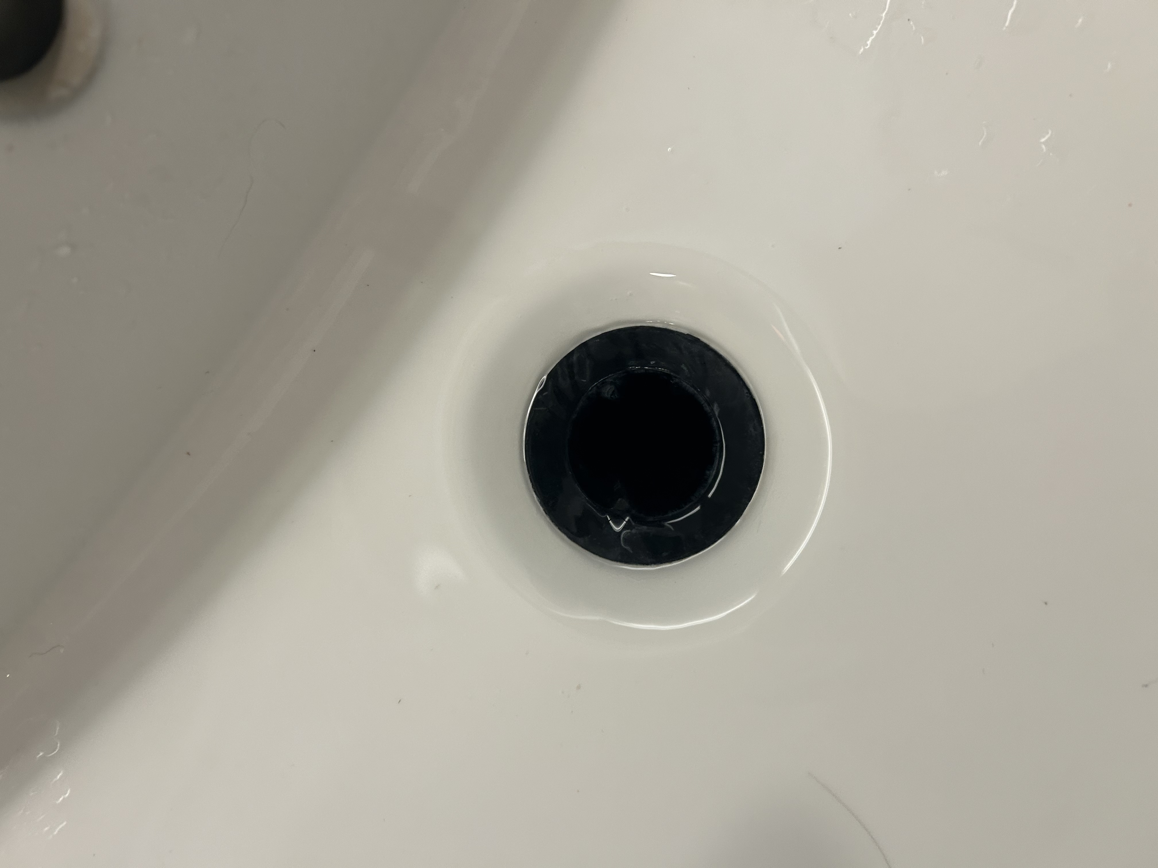 Guest bath sink drain after clearing — water draining freely — Desert Rain Plumbing Scottsdale AZ