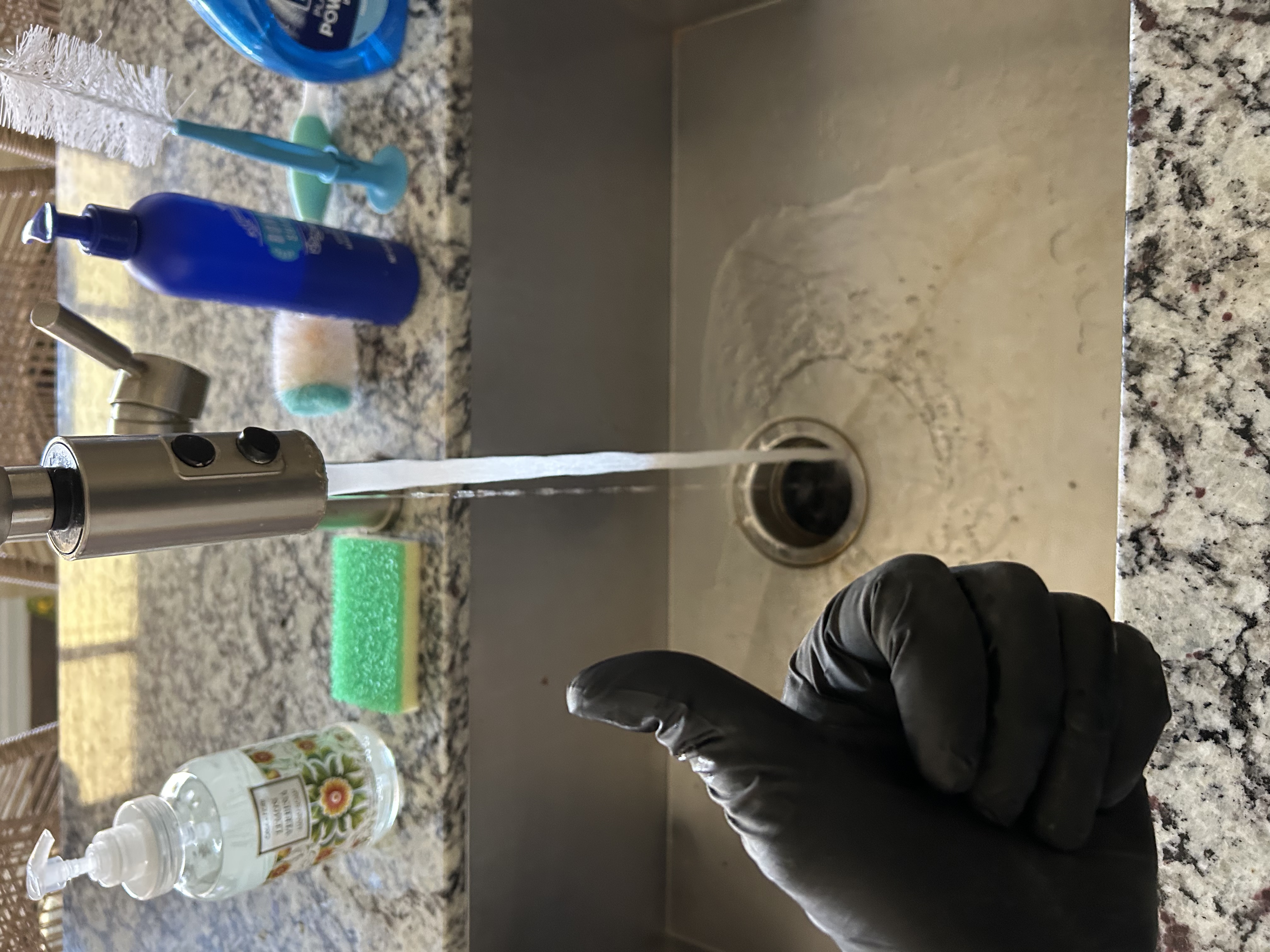 Running water test after garbage disposal repair — disposal draining properly — Desert Rain Plumbing Peoria